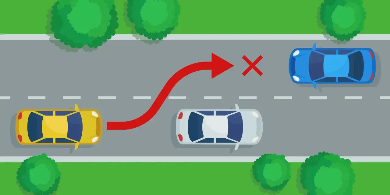 Żółty samochód próbuje niebezpiecznego wymijania niebieskiego auta, ignorując białe auto i czerwony znak zakazu.